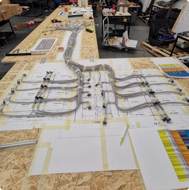 LATANIR cable harness laid out on a production table